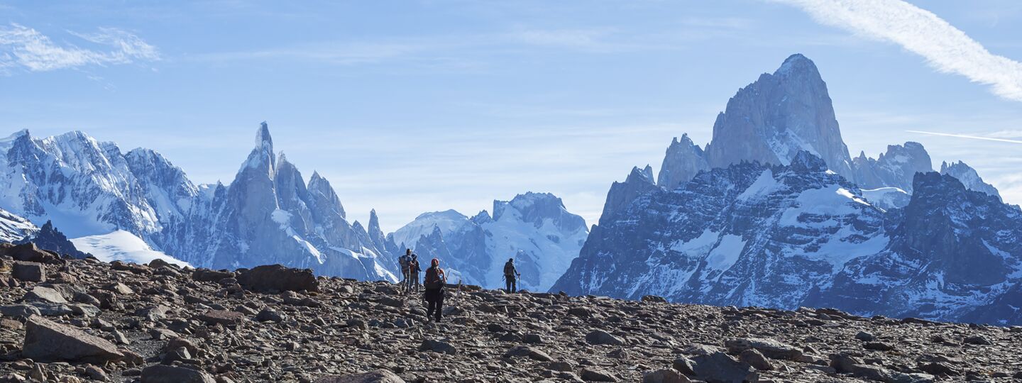 Hikers on Loma del Pliegue Tumbado, facing Cerro Torre and Fitz Roy